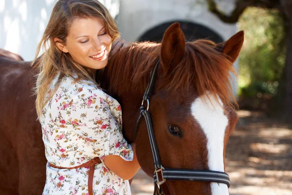 Happy, love and young woman with her horse on an outdoor farm for sports racing. Smile, training and confident female person from Canada with her equestrian animal or pet in countryside ranch