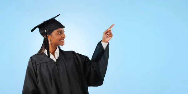 Graduate student, studio and happy woman point at school direction, university commercial or college knowledge development. Mockup space, graduation and higher education choice on blue background.
