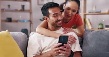 Mutlu çift, evde kadın ve erkekle sarılıp akıllı telefon, sosyal medya ve iletişim ile birlikte gülüyorlar. Komik mim, eğlence, teknoloji ve mobil uygulama ile ilişki içinde sevgi ve özen.