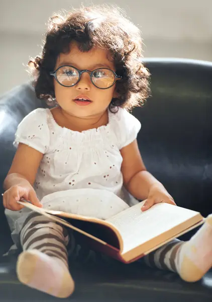 リラックスして ソファーと子供は 家で教育 知識の本を読んでいます ソファーで勉強したり子供時代を過ごすためのストーリーとメガネを持つ朝 スマートで女の子 — ストック写真