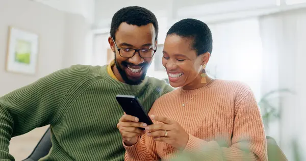 Happy, home phone and relax black couple reading, smile or watch social media video, blog or relationship news. Smartphone, mobile application and African man, woman or marriage people check web info.