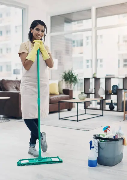 Nothing says welcome home like a clean house. a young woman cleaning her home