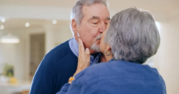 Care, love or old couple kiss in home to relax for connection, support, bond for trust or comfort. Elderly people in marriage, house or retirement with commitment, affection or romance together.
