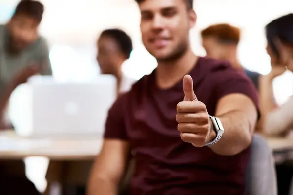 Stay positive and you will prosper. Closeup shot of a young businessman showing thumbs up in an office
