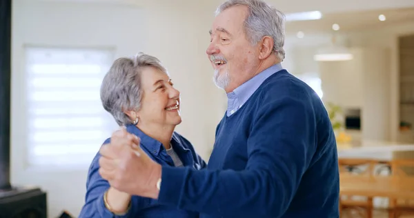 Home, dance and senior couple with love, happiness and retirement with romance in a living room. Romantic, elderly woman and old man with celebration, move and anniversary with a smile and cheerful.