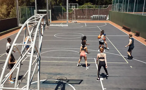 The pros are at play. a group of sporty young people playing basketball on a sports court