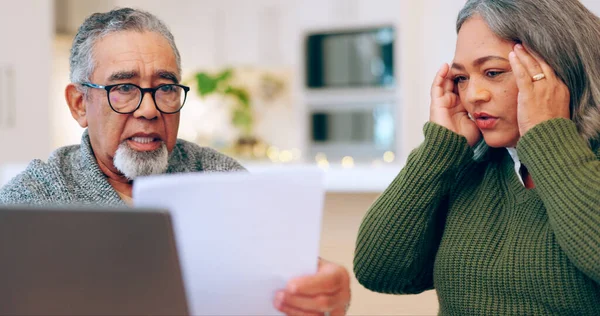 Senior couple, stress and documents for tax, debt and bills, bankruptcy or retirement. Elderly man, woman and paperwork in financial crisis, planning budget or asset management in living room at home.