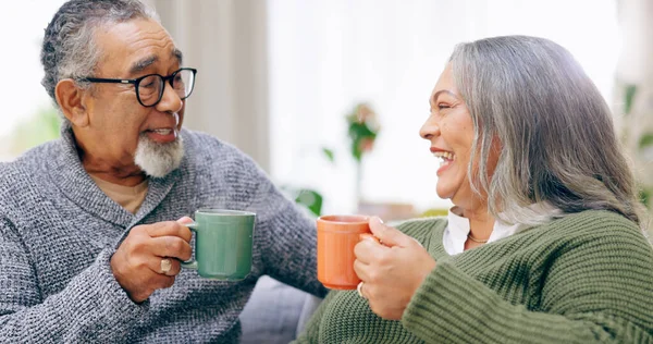 Senior couple, conversation and happy for coffee, home and retired for love, relax and enjoy. Retirement, old age and elderly in house, bonding together and quality time for discussion, man and woman.