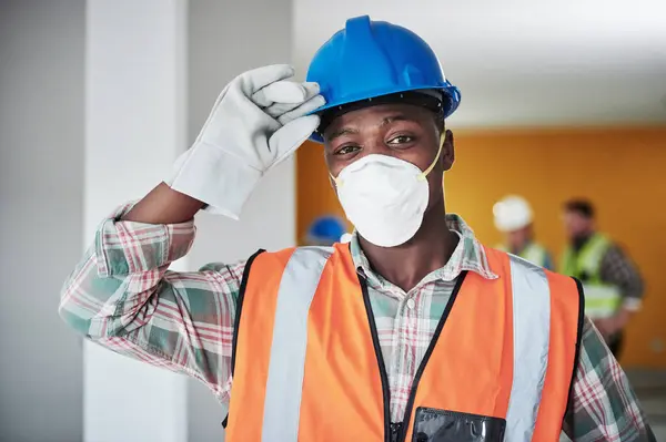 Our safety rules are the most important tools. Portrait of a confident young man working at a construction site