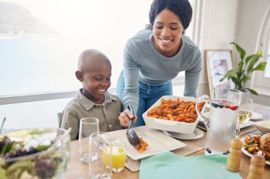 Whatever you call it, you need family. a mother dishing food for her son at home clipart