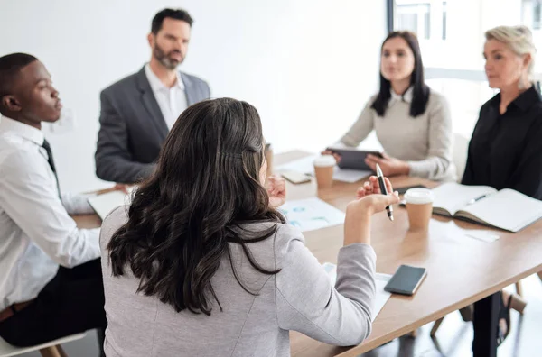 stock image She leads the meeting. a group of businesspeople in a meeting at work