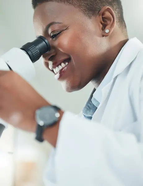 Making informed decisions based off his thorough research. a young woman using a microscope in a lab