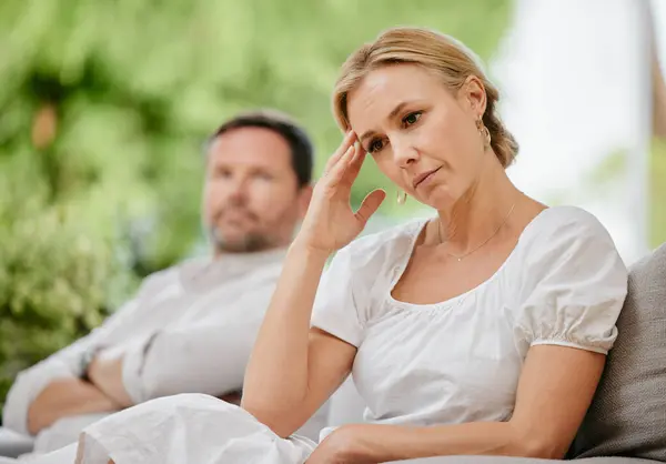 Mature woman looking upset and annoyed after arguing with her husband about marriage problems. Feeling negative. This relationship could end in divorce if they continue to disagree and fight