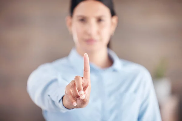 Closeup of of the hand in the foreground of a mixed race businesswoman gesturing stop or wait while standing in her office. Stop gender based violence and sexual harassment in the workplace. Take a s.