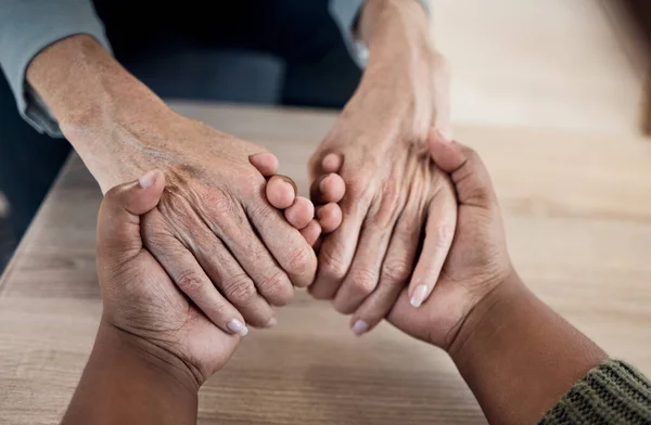 Holding hands, support and prayer, trust with people and counseling top view, psychology and therapy together. Kindness, respect and worship, help and wellness with communication, comfort and care.