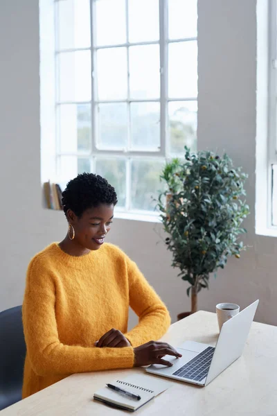 Remote work from home, business and black woman with a laptop, typing and deadline with happiness, connection and internet search. Female person, lady or entrepreneur with a pc or website information.
