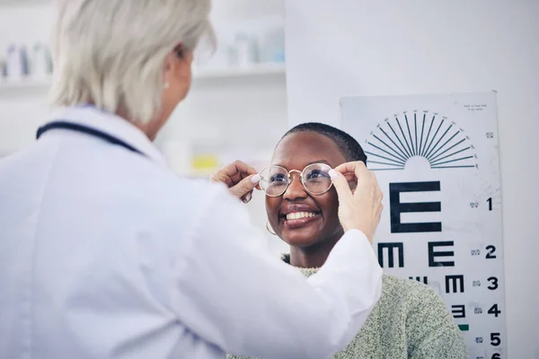 Eye exam, glasses and vision, doctor and patient with women in optometry clinic, health insurance and help. Prescription lens, frame and eyesight, healthcare for eyes and ophthalmology with eyecare.