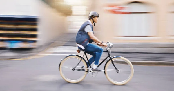 Student man, bike and city in motion blur, speed and sustainable travel in street for fitness in summer. Young guy, retro bicycle and fast with eco friendly transport in metro, road or outdoor in cbd.