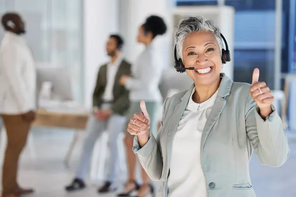 Senior woman, call center and smile with thumbs up for good job, thank you or agree at office. Portrait of elderly female consultant or agent showing thumb emoji or sign for success, winning or yes.