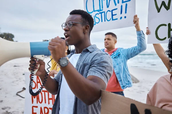 Protest, climate change and megaphone with black man at the beach for environment, earth day and action. Global warming, community and pollution with activist for social justice, support and freedom.
