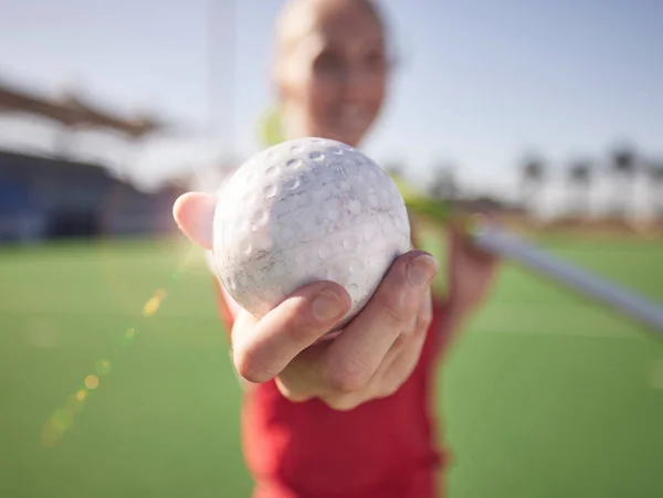 Sport, ball in hand and hockey on field with athlete and fitness outdoor for training on stadium turf. Hockey player, workout and sports closeup, field hockey and active with healthy lifestyle