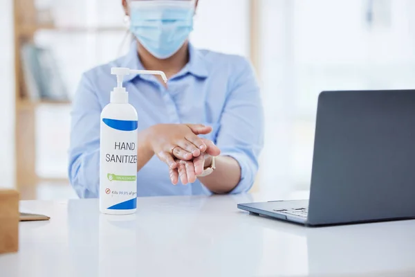 Covid, business woman at desk and hand sanitizer for hygiene and safety, protection against virus. Cleaning, laptop and health compliance of corporate, medical policy and clean working environment