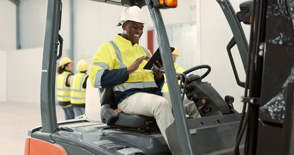 Construction site, tablet and black man in forklift machine for maintenance, planning and building renovation. Logistics, shipping and contractor on digital tech for online report in warehouse.