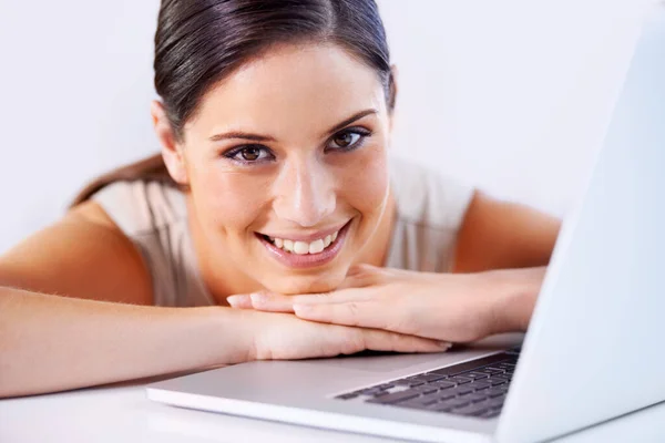 Happy, laptop and business woman in office with positive, good and confident attitude for career. Smile, pride and professional young female creative designer from Canada with computer in workplace