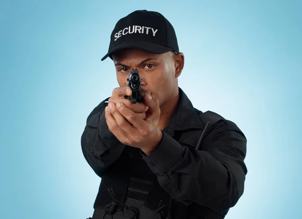 Man, security guard and pointing gun for shooting, protection and hands with face, portrait or confident. Target, safety or weapon for criminal, aim or studio background for pistol, crime or arrest.
