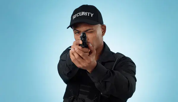 Man, security guard and pointing gun to aim, protection and hands with face, portrait or confident. Target, killing or weapon for criminal, murder or studio background for pistol, crime or eye closed.