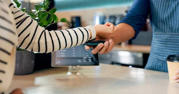 Smart watch, payment or hands of barista in cafe with cashier for shopping, sale or checkout. Fintech machine, customer or closeup of person paying for service, coffee cup or tea bills in restaurant.