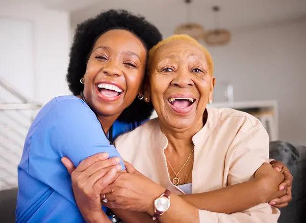 Black people, nurse and patient hug in elderly care for love, support and trust together on sofa at home. Portrait of happy African medical caregiver enjoying time with senior female person in house.