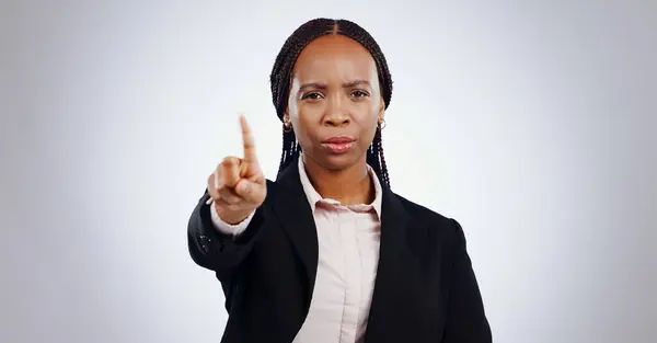 Stop, finger and portrait of business woman in studio with warning, no or limit on grey background. Protest, palm and face of lawyer with emoji vote, threat or control order, security or not allowed.