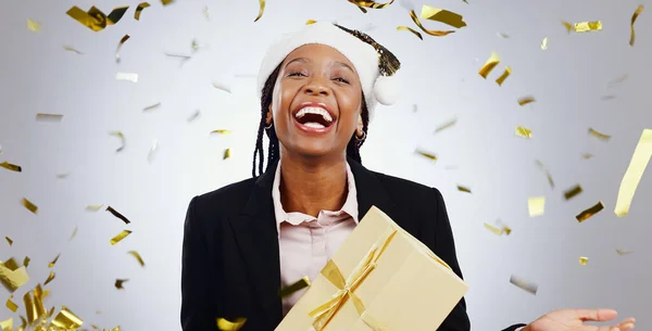 Portrait, confetti and business with black woman, present and celebration on a white studio background. Face, African person and employee with a gift, winning and hat with giveaway and achievement.