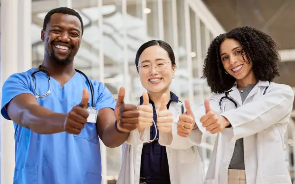 Thumbs up, success and team of doctors for healthcare support, thank you or excellence in hospital services. Medical group of people like, yes and okay hands or emoji, clinic diversity and portrait.