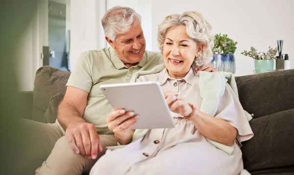 Senior couple, tablet and smile on sofa in home living room for news app, movies or streaming internet show. Happy woman, elderly man and digital technology for social media, reading ebook or website.