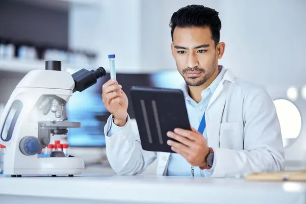 Science, tablet and man in laboratory with test tube for research, study and sample analysis. Healthcare, biotechnology and scientist online with medical equipment for vaccine, analytics and medicine.