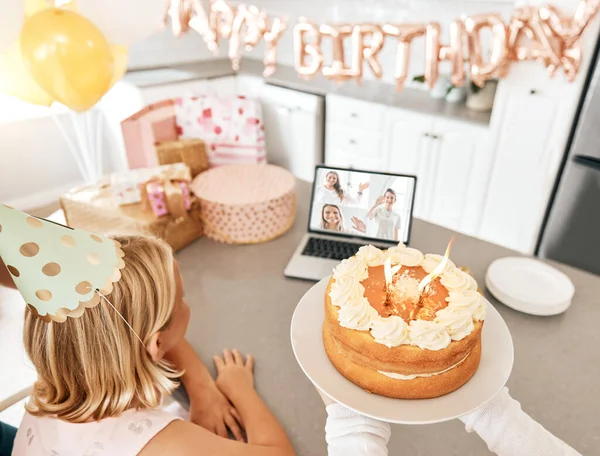Birthday party during covid, video call and celebration with friends and family on Zoom. Girl having a internet, cyber or virtual social distancing gathering with cake and presents during pandemic.