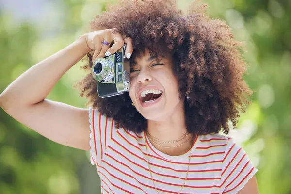 Nature, afro and black woman with photography camera taking happy picture memory with retro style. African hipster girl with smile in park using vintage photographer equipment to capture moment