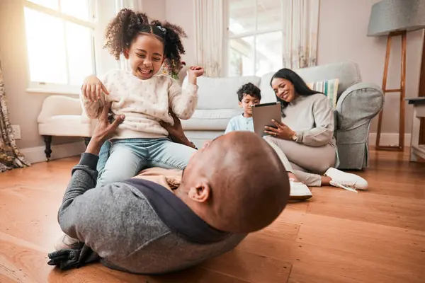 Father, girl and play in home, funny and bonding together with love and care. Dad, child and laughing on floor in living room lounge for family time to relax, smile and happy in interracial house.