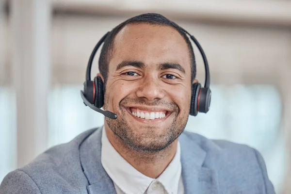 Call center, smile and face of man with headphones in office for telemarketing, support and crm. Contact us, portrait and customer service professional, sales agent and happy consultant from Brazil.