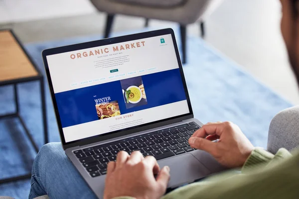 Online shopping menu, laptop screen and person hands reading healthy food homepage, restaurant web store or nutrition catalog. About us, organic market info and home customer search website for lunch.