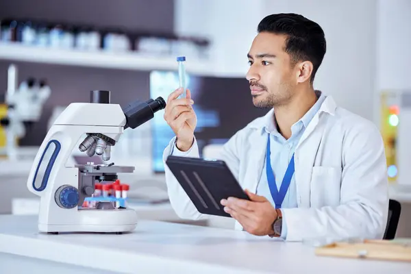 Science, microscope and man with sample and tablet in laboratory for research, test and analysis. Healthcare, biotechnology and scientist with medical equipment for vaccine, innovation and medicine.