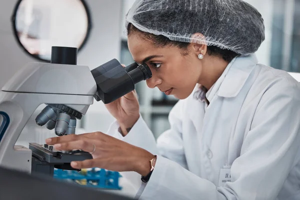 Scientist, black woman and microscope, analysis of data and science innovation, microbiology or biotechnology in lab. Work, scientific study and researcher, doctor and test with medical research.