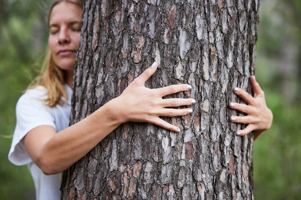 Woman, hug and tree with care for environment or conservation in outdoor for eco friendly person. Love, protection and hands in forest to save for nature with meditation in park for ecology