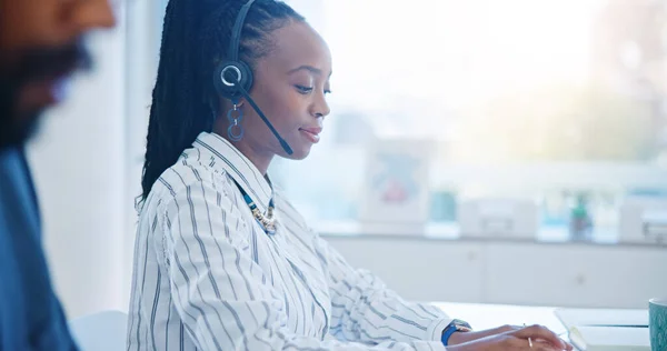 Black woman, call center and drinking coffee in customer service, support or telemarketing at the office. African female person, consultant or agent enjoying hot beverage in contact us at workplace.