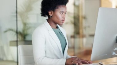 Modern bir ofiste odaklanmış, düşünen ve bilgisayar üzerinde çalışan ciddi bir siyahi iş kadını. Bir şirket şirketinde başarılı olmak için kararlı ve motive olmuş genç profesyonel duygular..
