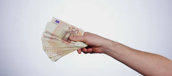 Cash in hand, finance and wealth with bonus, euro notes or bills with lotto winner on white background. Financial freedom, rich person and money fan with payment, investment or savings in a studio.