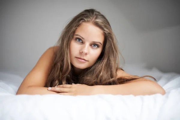 House, woman portrait and bed with sleeping, rest and relax in a bedroom with face and calm. Dreaming, female person and confidence with nap at home on a blanket and sheets lying down with thinking.