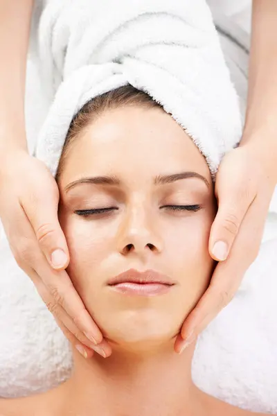 Spa massage, peace and hands on face of woman from above at resort for stress relief or wellness. Top view, facial and female client with masseuse at beauty salon for luxury, skincare or dermatology.
